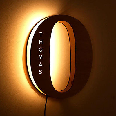 Wall-mounted light fixture with 'THOMAS' branding on a brown background