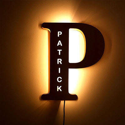 Letter 'P' shaped light fixture with 'Patrick' text on a brown background