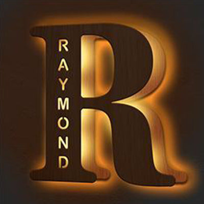 Wooden letter 'R' with engraved name 'Raymond' on a dark background