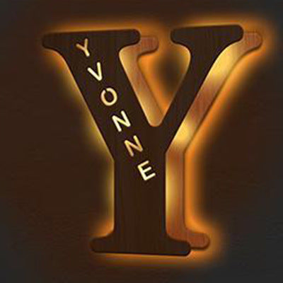 Decorative letter 'Y' with 'YVONNE' engraved on a dark background