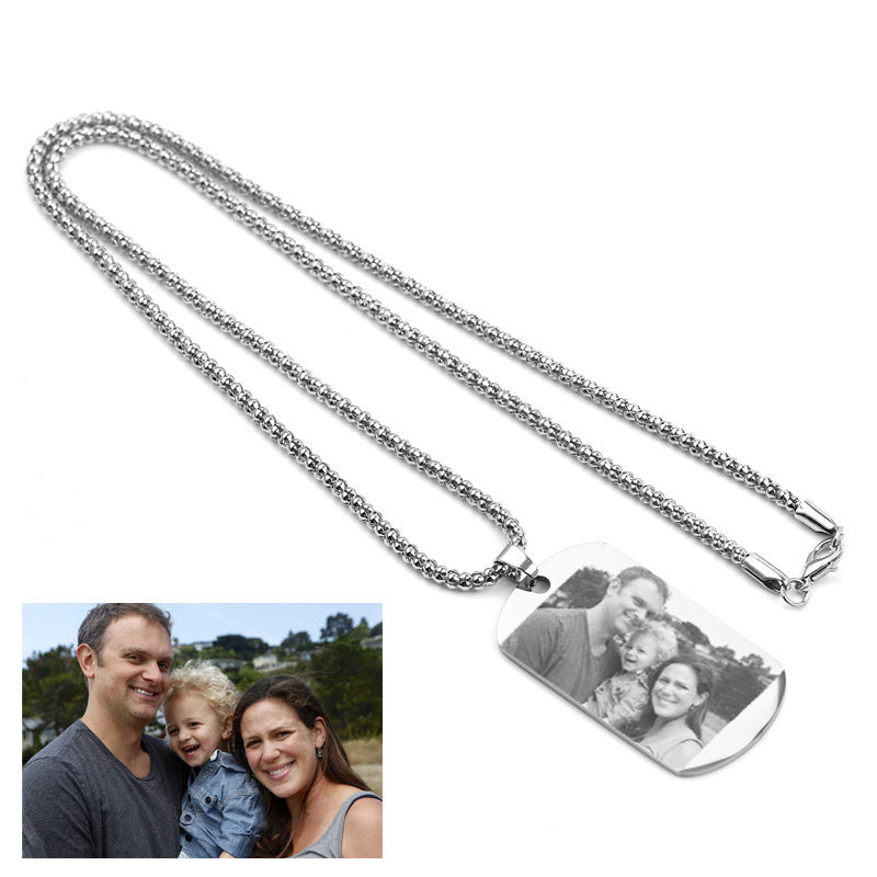 Silver necklace with a pendant featuring an engraved family photo on a white background.