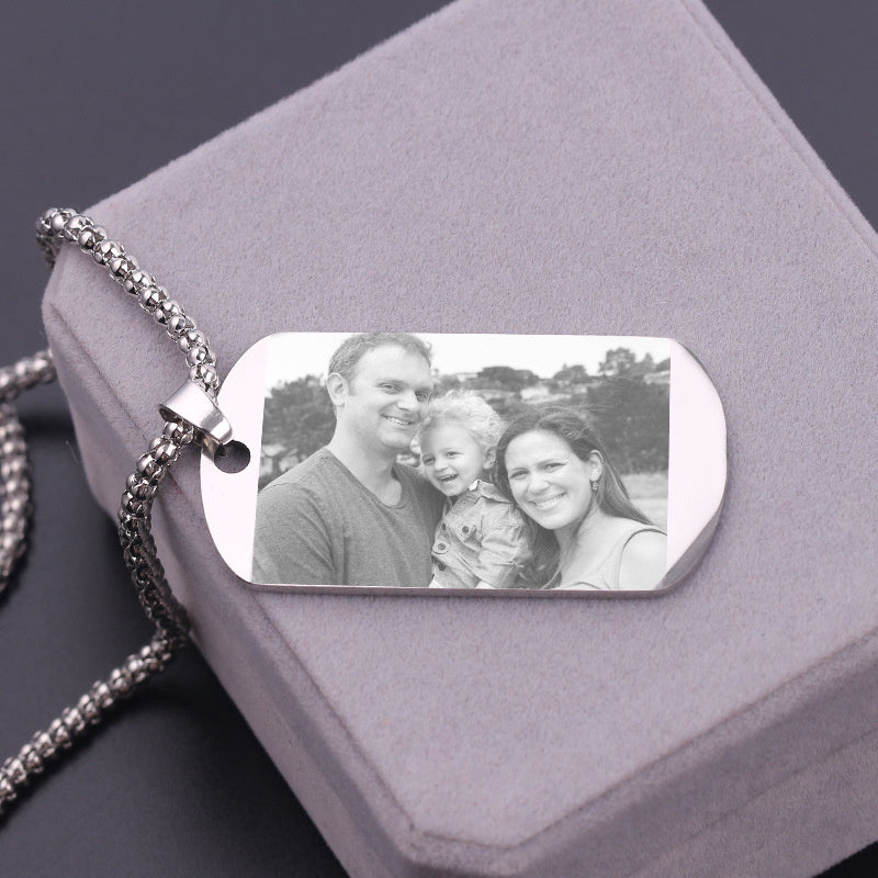 Personalized necklace tag with a photo of a family on a gray jewelry box.