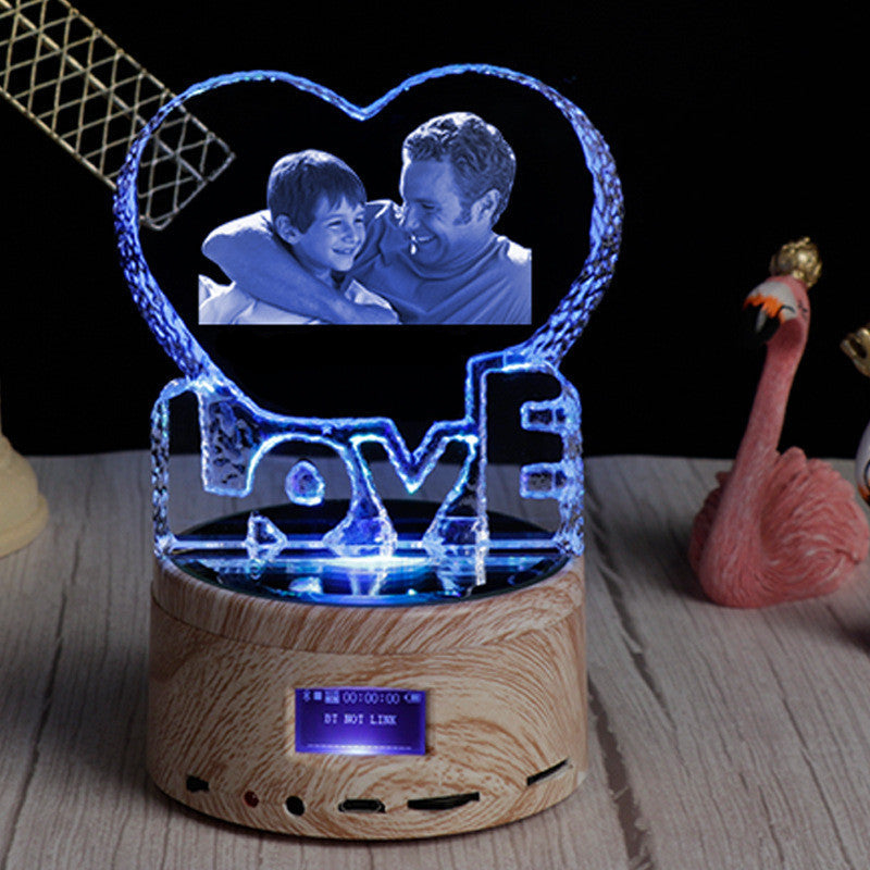 Heart-shaped LED lamp with a wooden base displaying a photo of two people and the word 'LOVE'.
