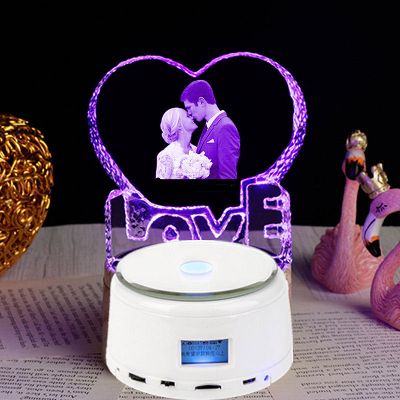 LED night light with heart-shaped design of a couple and 'Love you forever' text, placed on a surface with decorative items.