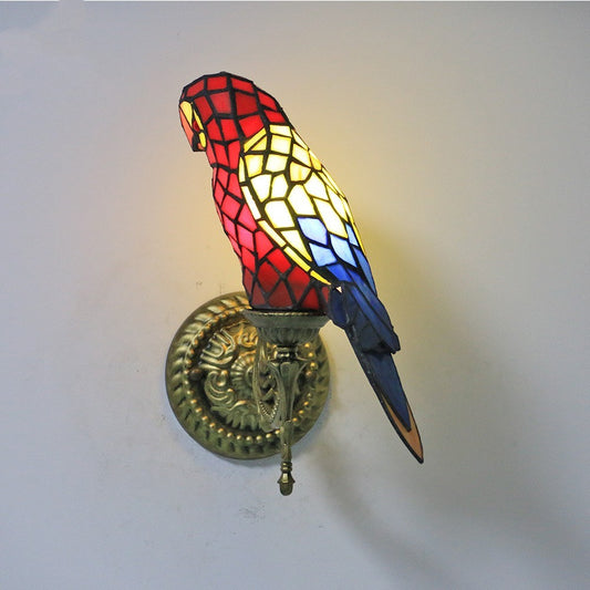 Decorative wall light shaped like a parrot with stained glass design on a white background