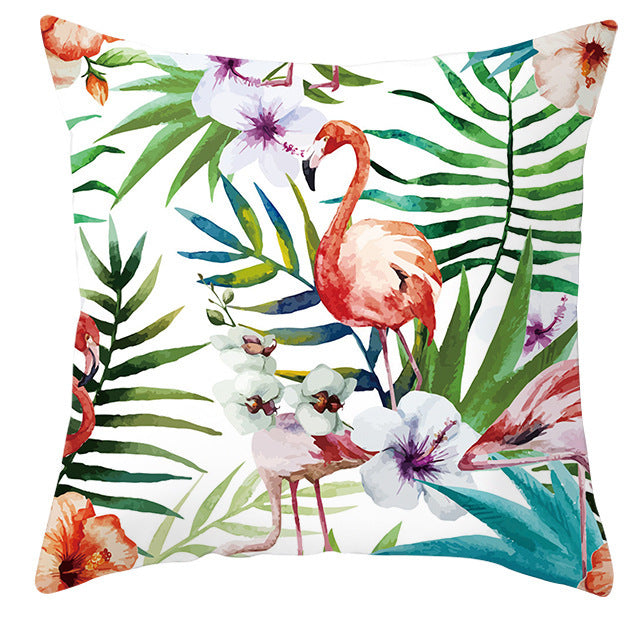 Decorative pillow with flamingo and tropical leaf pattern