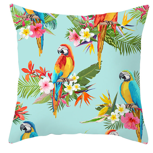 Decorative pillow with parrot and tropical flower pattern on a light blue background