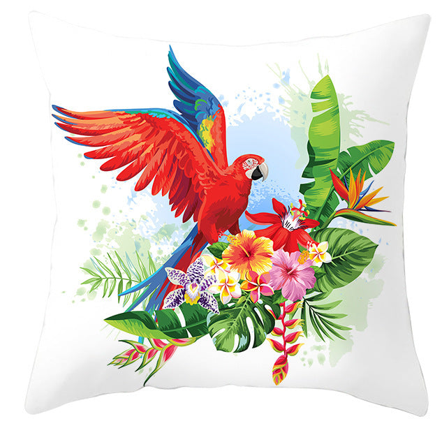 Decorative pillow with a colorful parrot and tropical flowers design on a white background