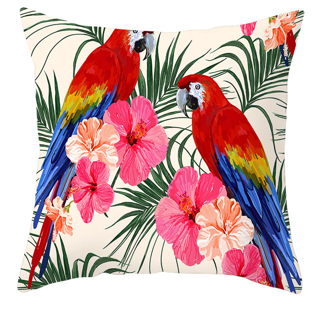 Decorative pillow with parrots and tropical flowers on a white background