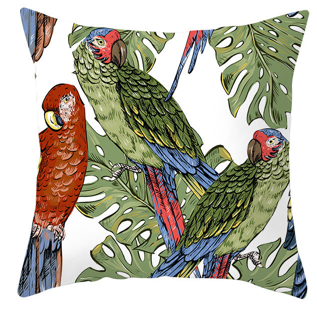 Decorative pillow with parrot and leaf design on a white background