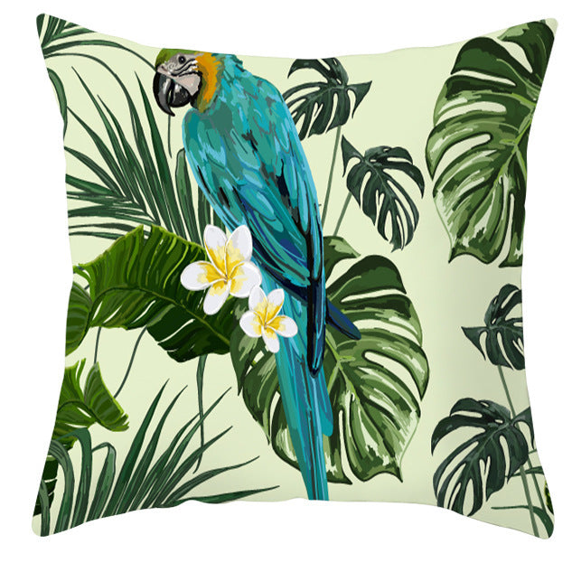 Decorative pillow with a parrot and tropical leaf design on a light green background