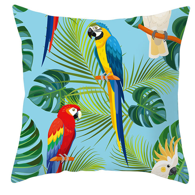 Decorative pillow with parrot and leaf design on a blue background