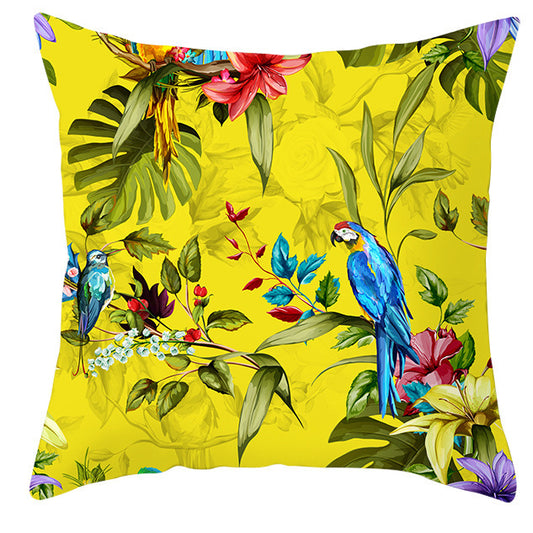Decorative pillow with tropical birds and flowers on a yellow background