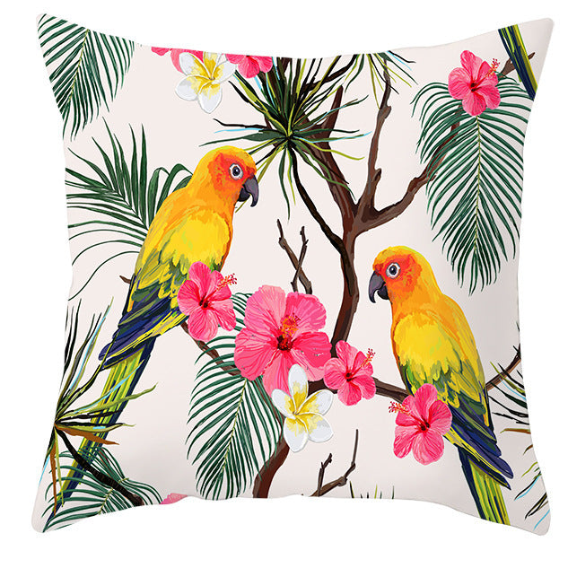 Decorative pillow with parrot and floral design on a white background