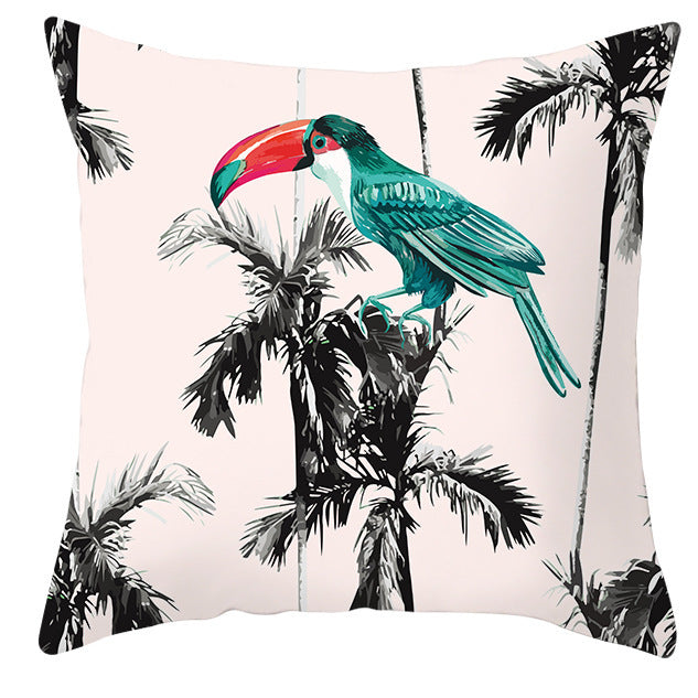 Pillow with a toucan and palm tree design on a white background