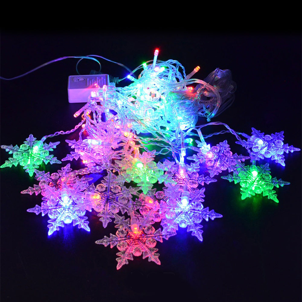 String lights with snowflake decorations on a black background