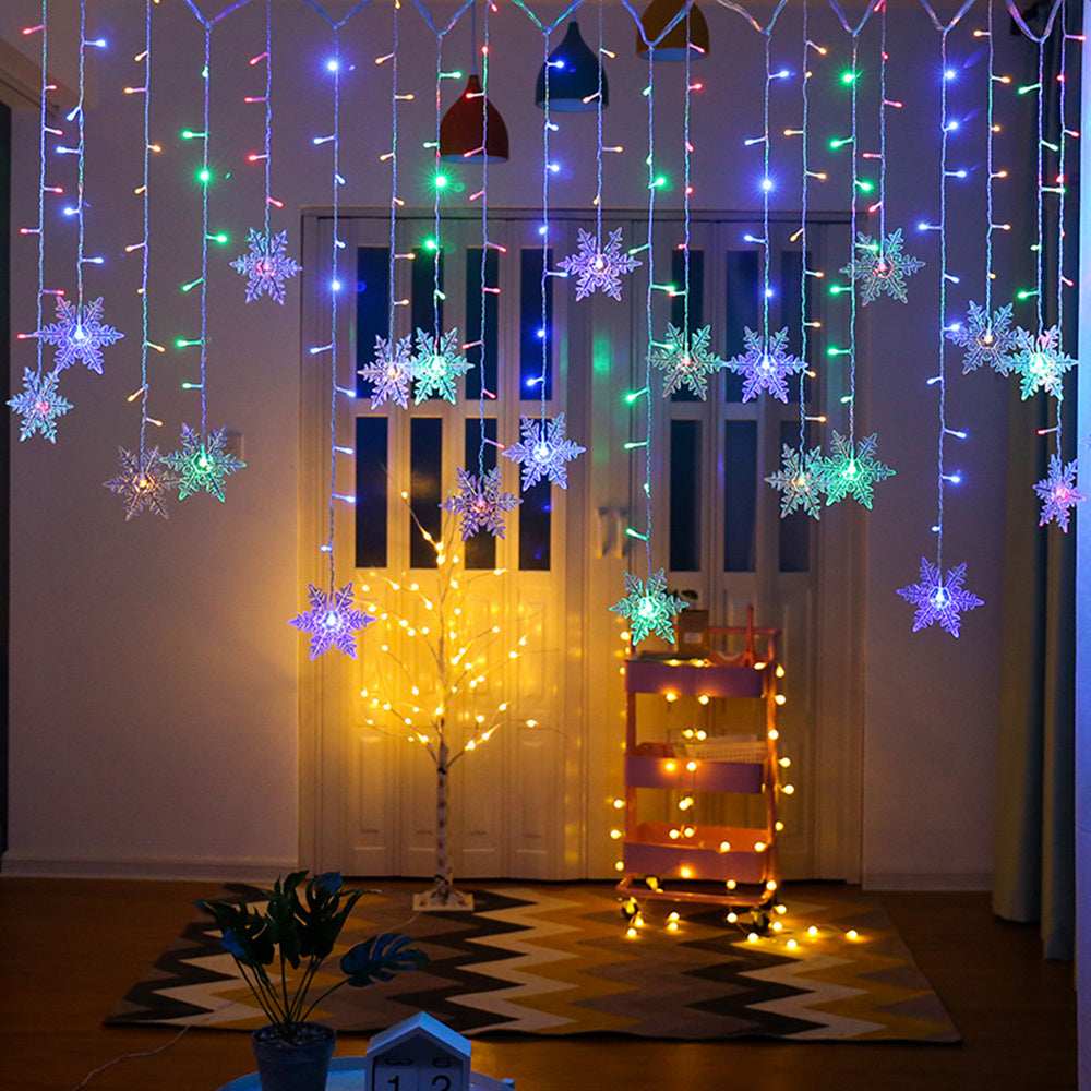 Decorative string lights with snowflake ornaments hanging in a room.