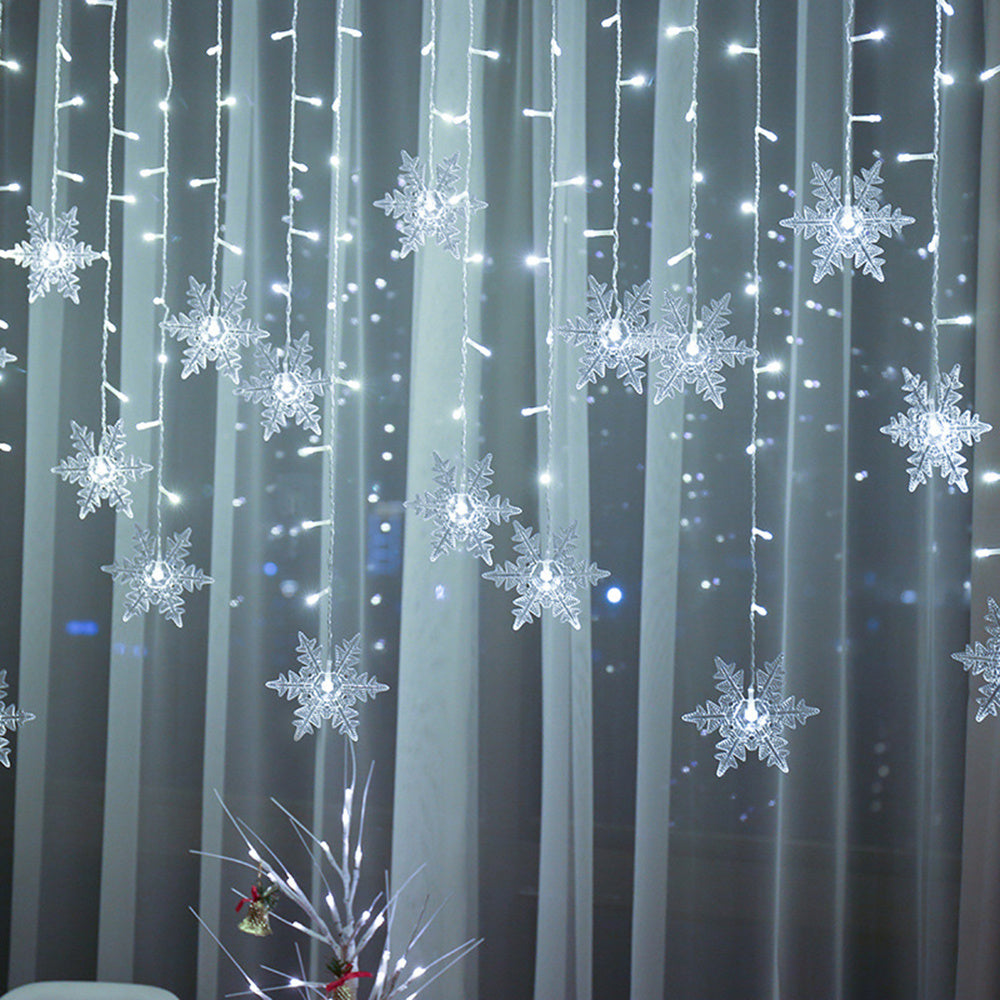 Snowflake-shaped LED lights hanging against a dark background