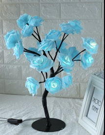 Decorative blue flower lamp on a white surface with a blurred background