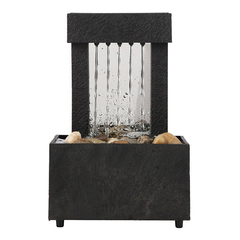 Black rectangular water fountain with glass panel and rocks on a white background