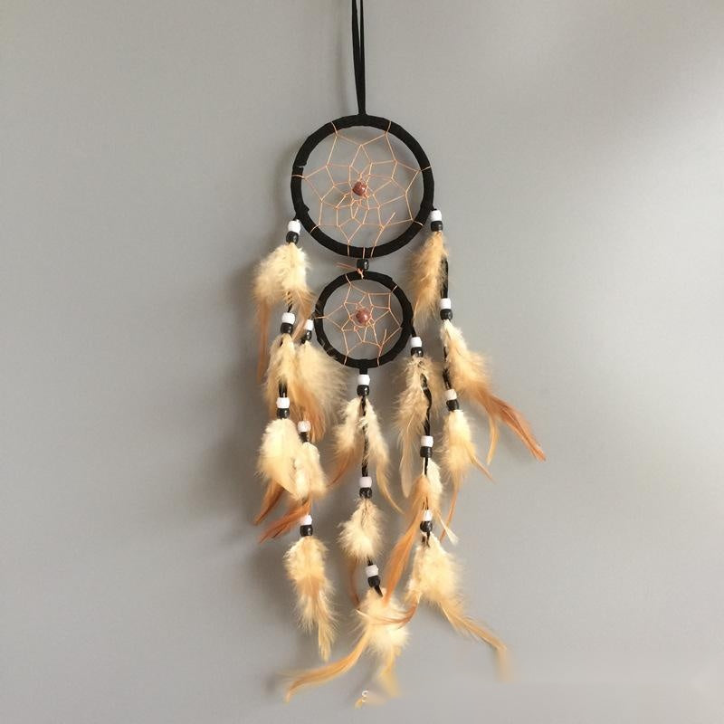 Dreamcatcher with feathers on a gray background