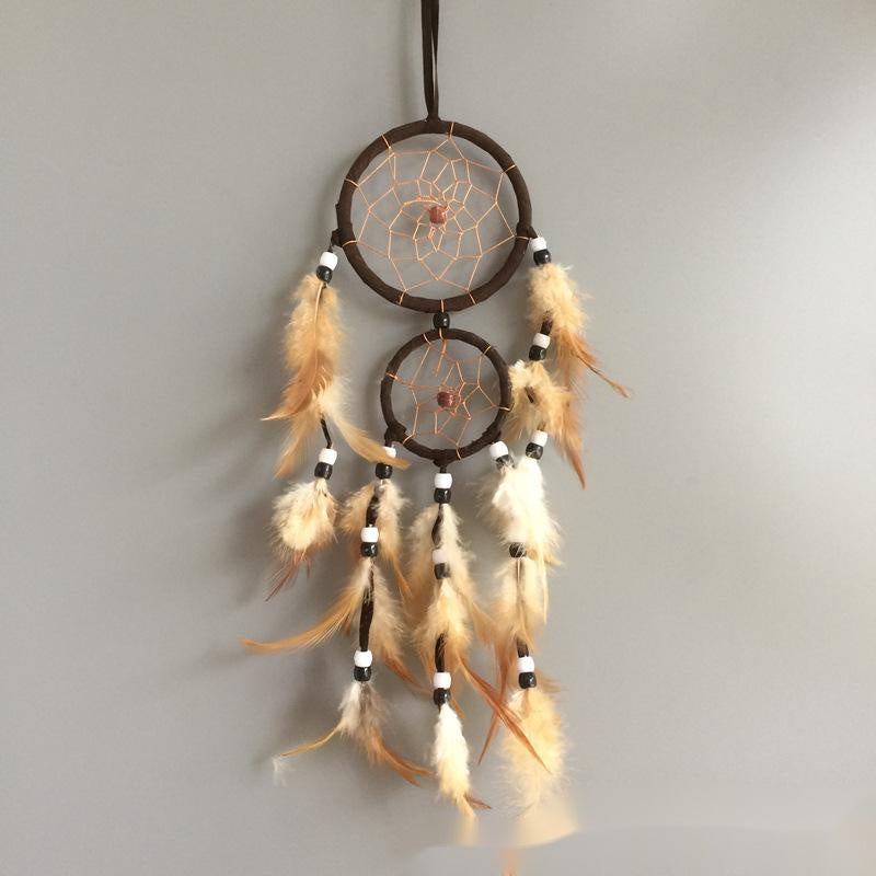 Dreamcatcher with feathers on a plain background