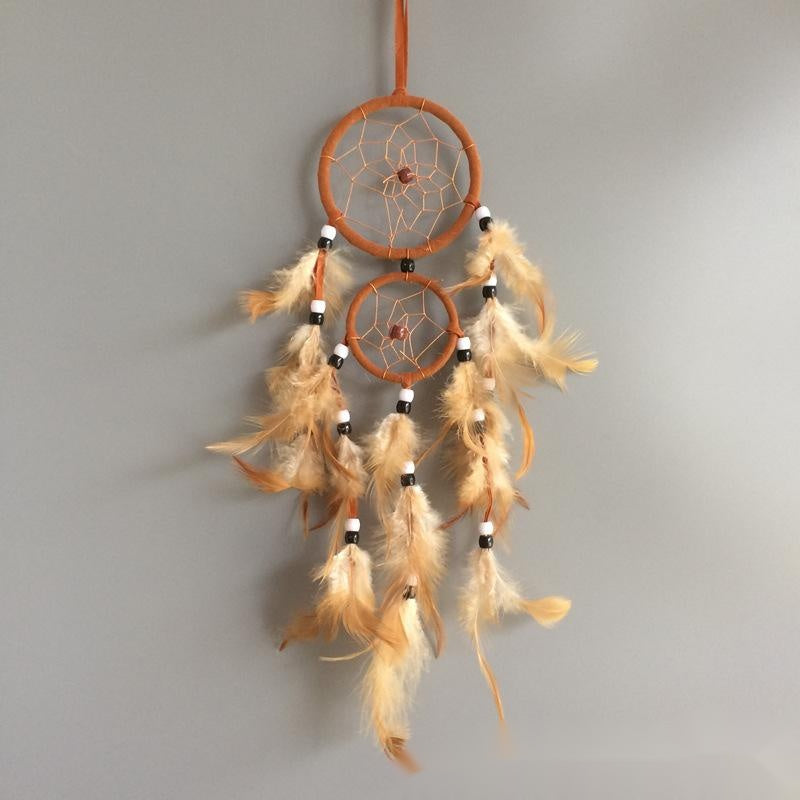 Dreamcatcher with feathers on a gray background
