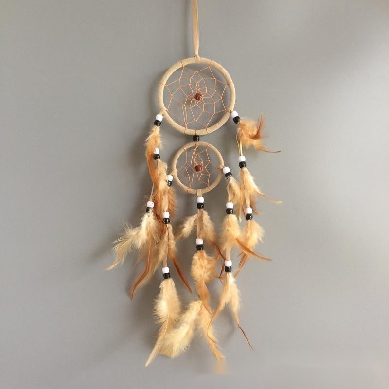 Dreamcatcher with feathers on a gray background