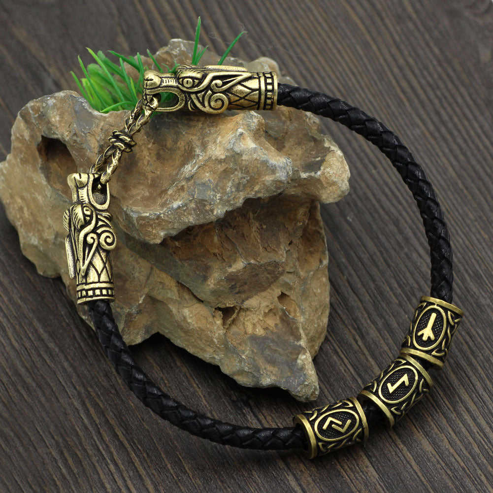 Bracelet with gold and black design on a wooden surface