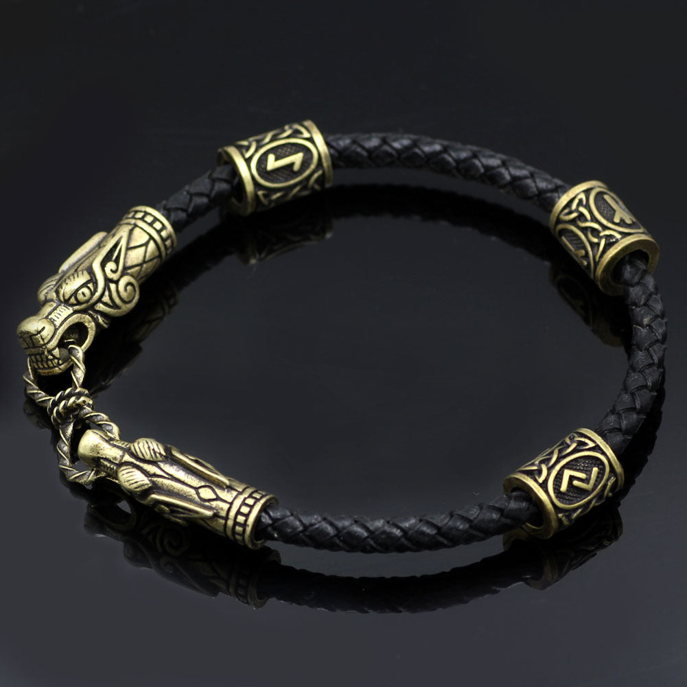 Black braided leather bracelet with gold Viking-style beads on a dark background