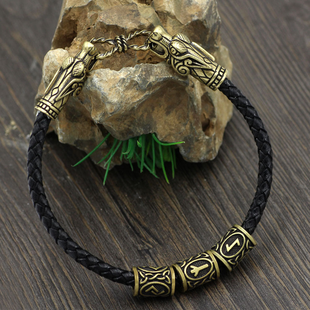 Bracelet with gold and black design on a wooden surface