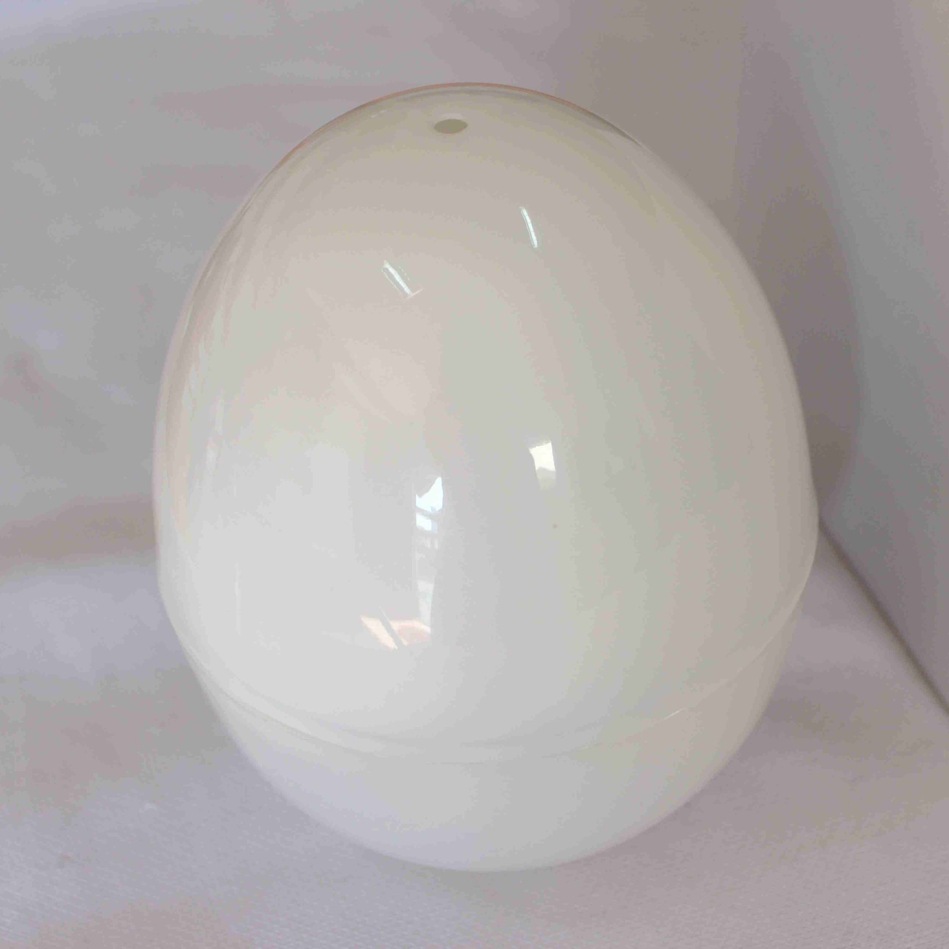 White ceramic egg-shaped object on a white background