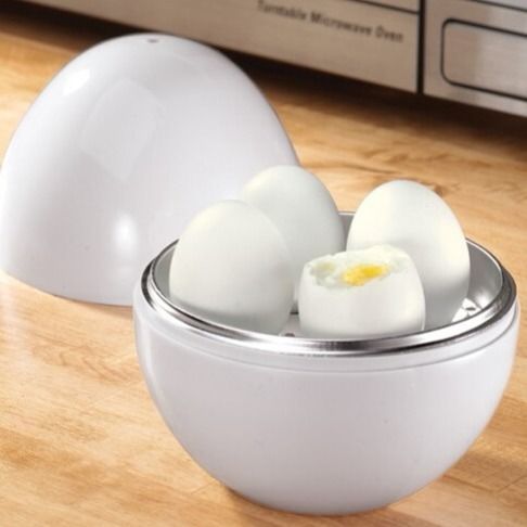 White egg holder with eggs on a wooden surface