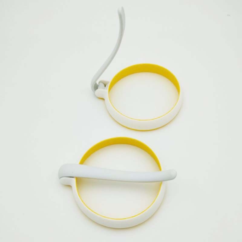 Two circular objects with yellow rims and white centers on a light gray background