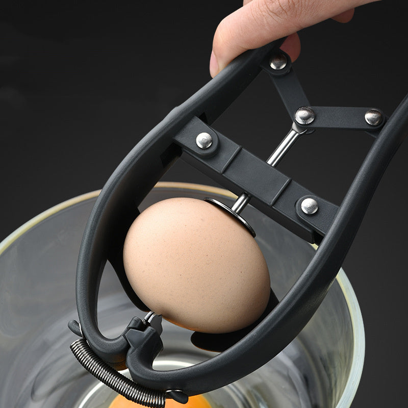 Egg being cracked open with a black eggcracker against a dark background