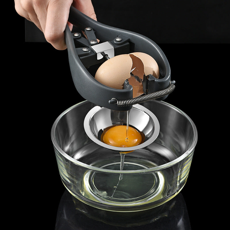 Egg separator with cracked egg over a glass bowl on a black background