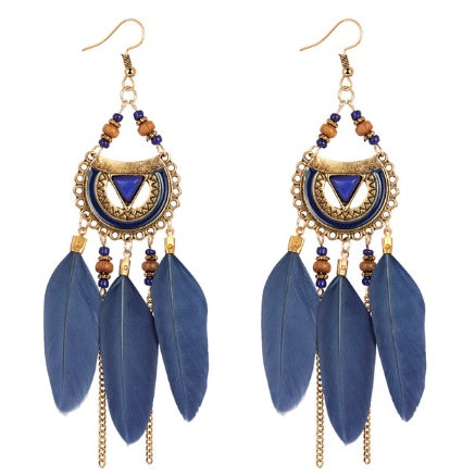 Blue feather earrings with gold and beaded accents on a white background
