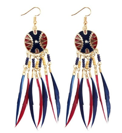Pair of black blue red feather earrings with gold chains and decorative elements on a white background