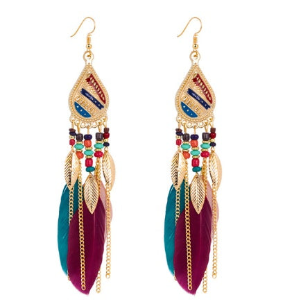 Colorful feather earrings with gold accents on a white background