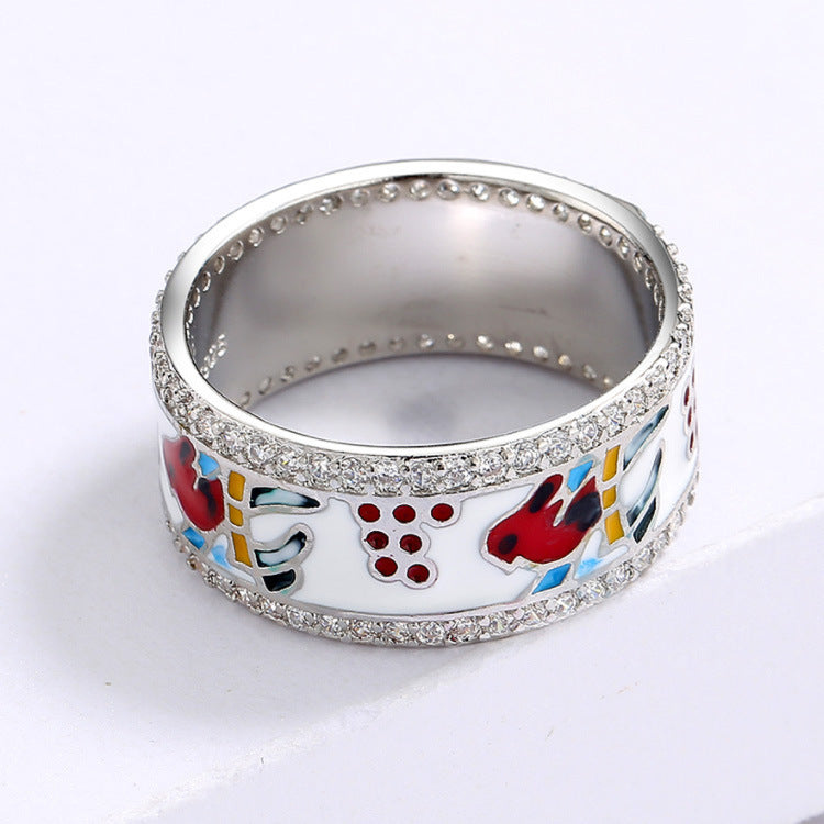 Silver ring with colorful designs on a white background