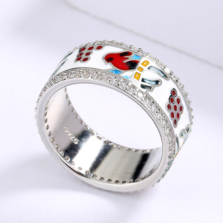 Silver ring with colorful designs on a white background