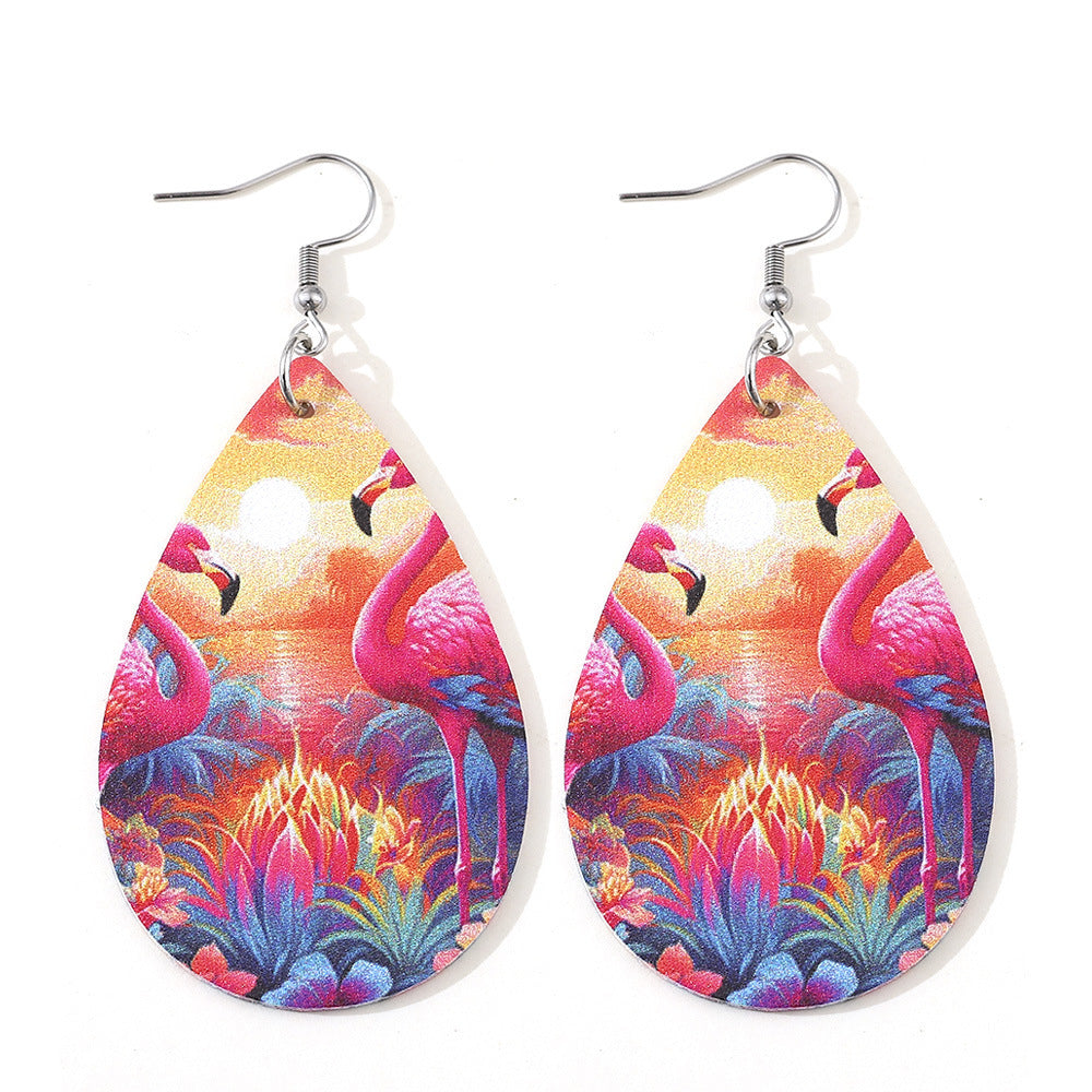 Teardrop-shaped earrings with flamingo design on a white background