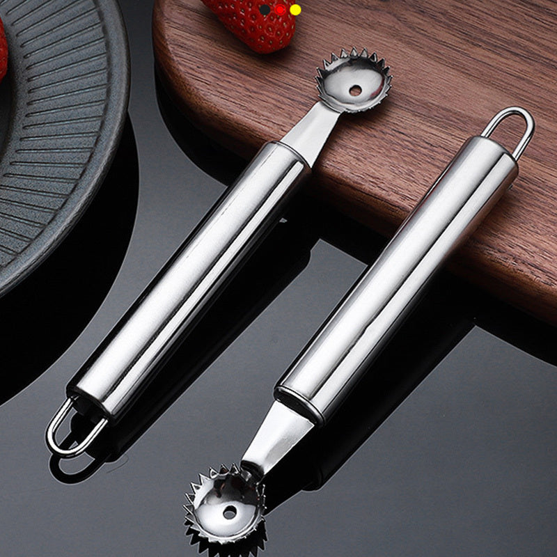 Two metal kitchen tools on a reflective surface with a wooden board in the background.