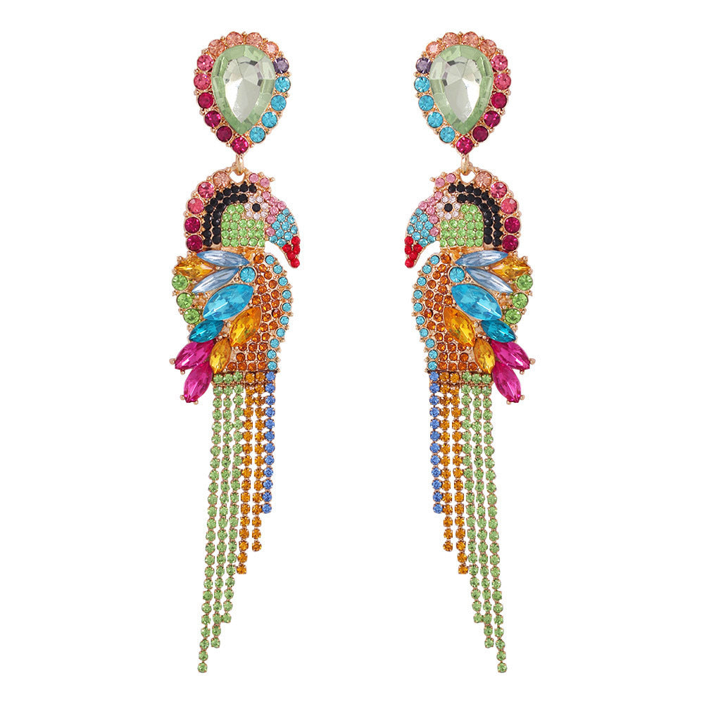 Colorful parrot-shaped earrings with gemstones on a white background