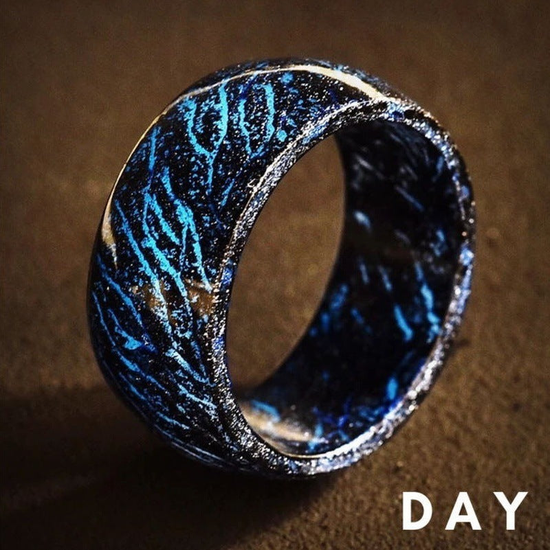 Ring with blue and black pattern on a brown background