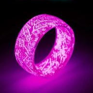 Neon sign with 'Disco Bar' text and a glowing pink ring on a dark background