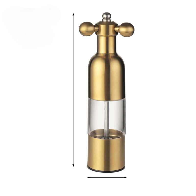 Gold pepper grinder on a white background