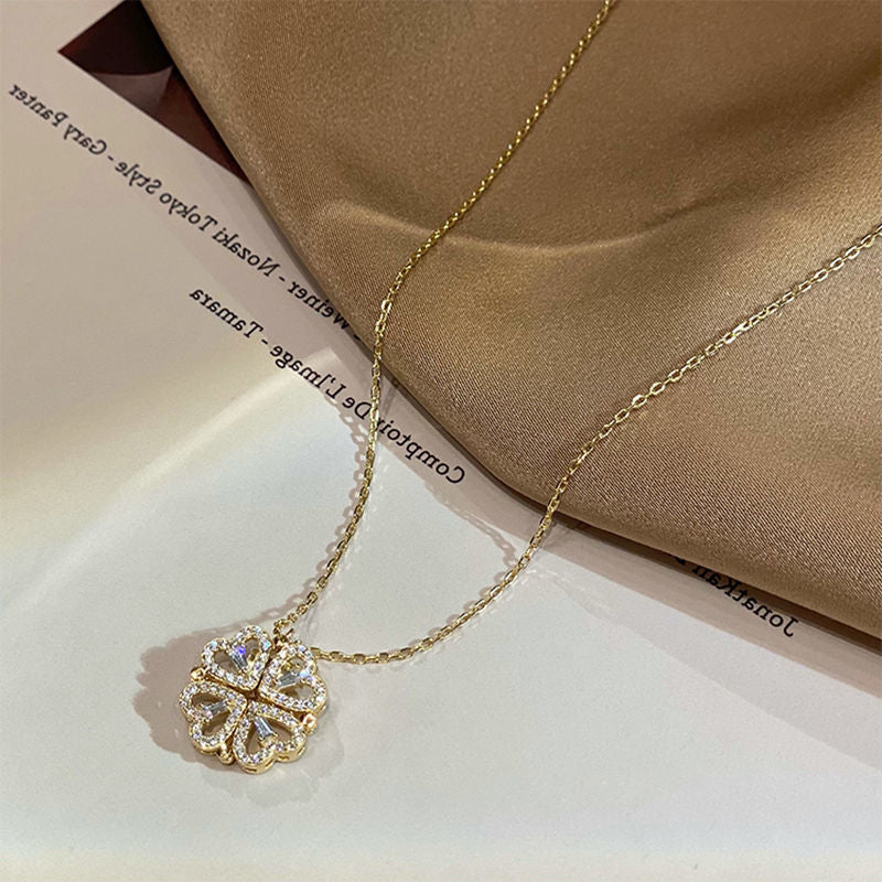 Gold necklace with a diamond pendant on a beige fabric background
