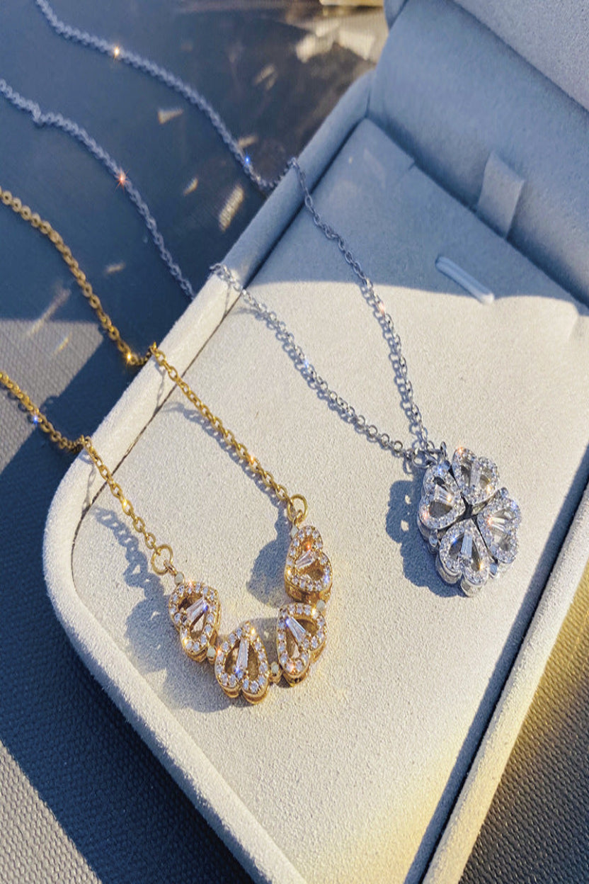 Two necklaces on a jewelry display box with a blue background
