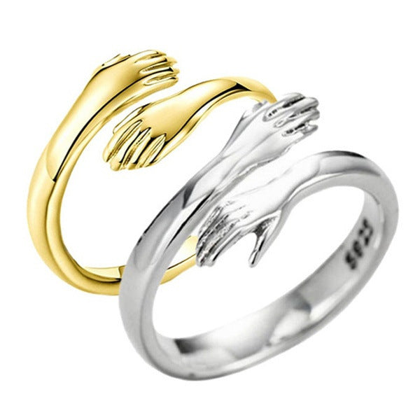 Gold and silver open hand ring on a white background